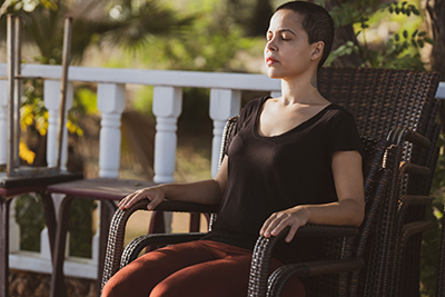 Women sitting in a chair with eyes cloesd